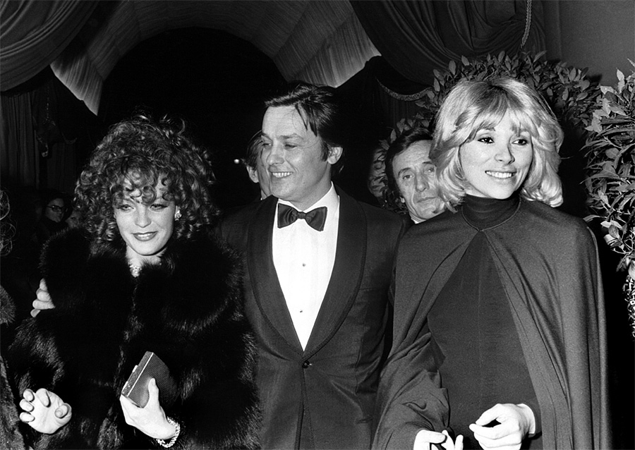 Alain Delon avec Romy Schneider et Mireille Darc lors d'une soirée - 1975 © Photo sous Copyright